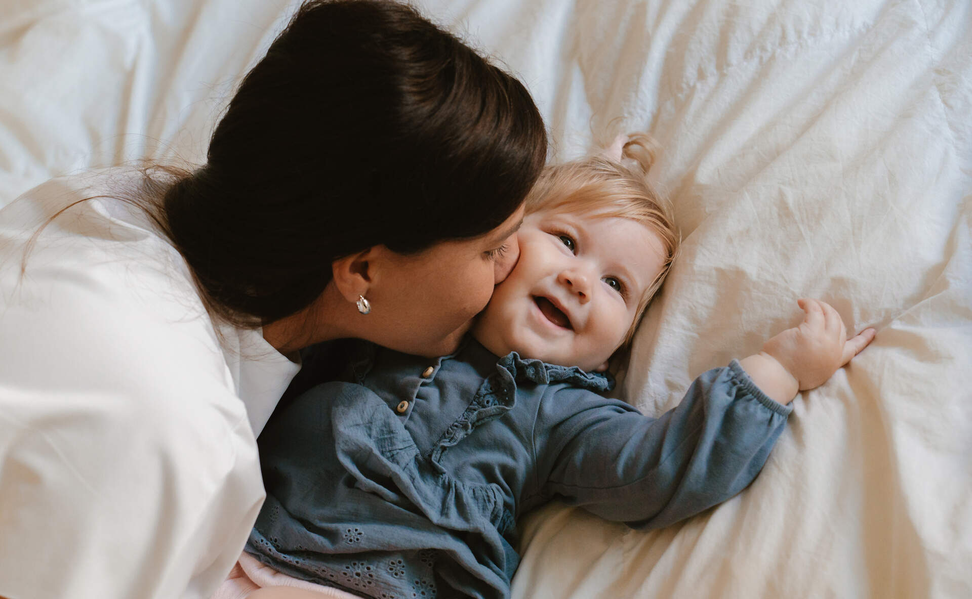 Mother kissing child